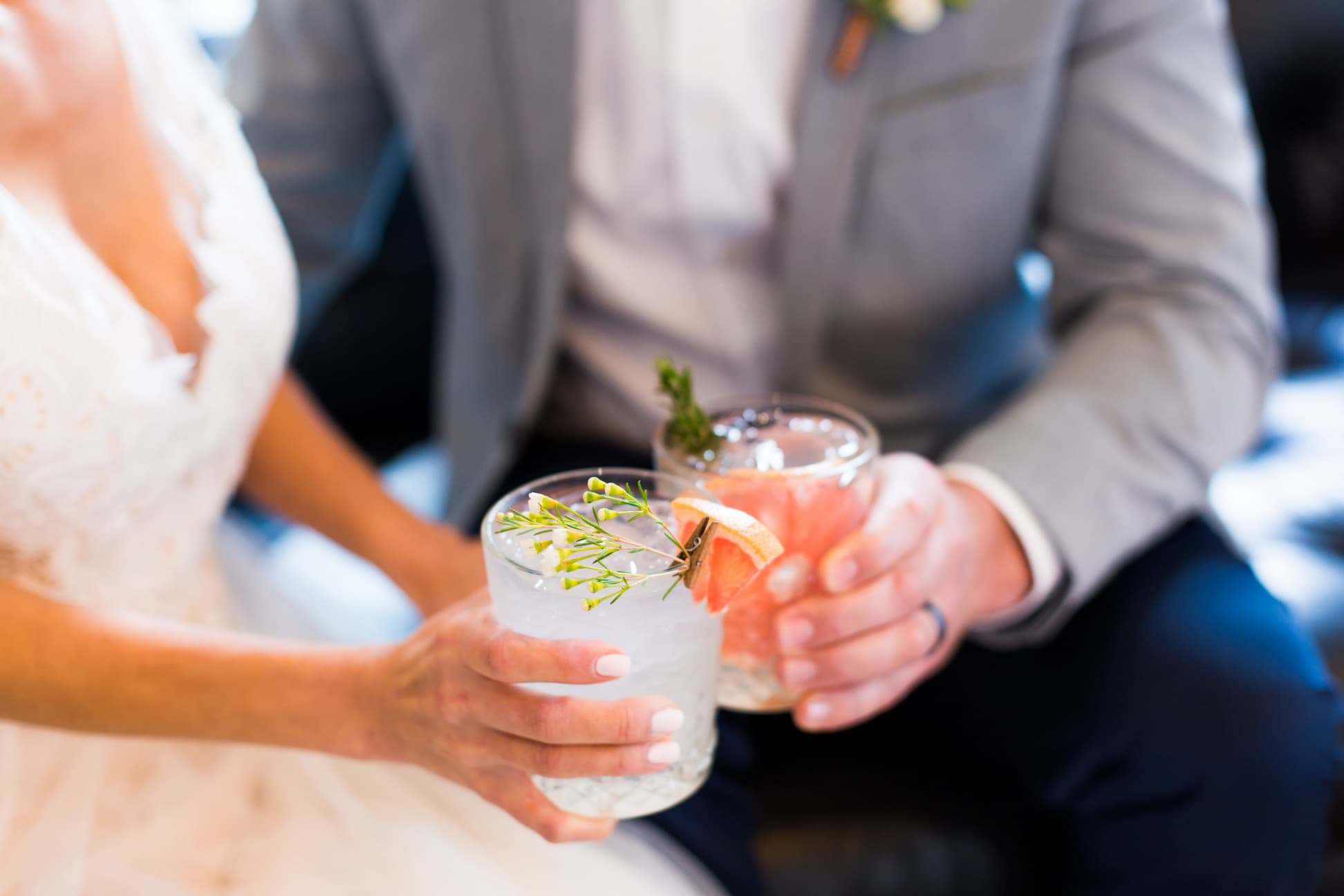Wedding couple toasting with cocktails
